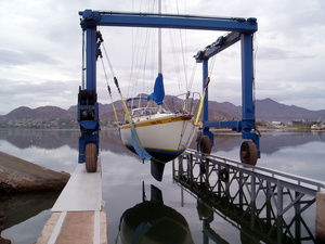 Travelift holding Hoku Pa'a just above water, ready to launch