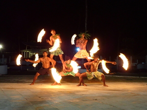 Five Fire-dance performers in a pyramid