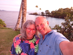 Barb and Bjarne selfie with palms and ocean at sunset