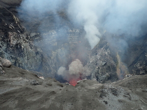 Start of eruption, in which gas plume and glowing lave pieces are starting to rise