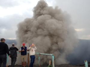 Ash cloud rising higher than four spectators filming with their phones